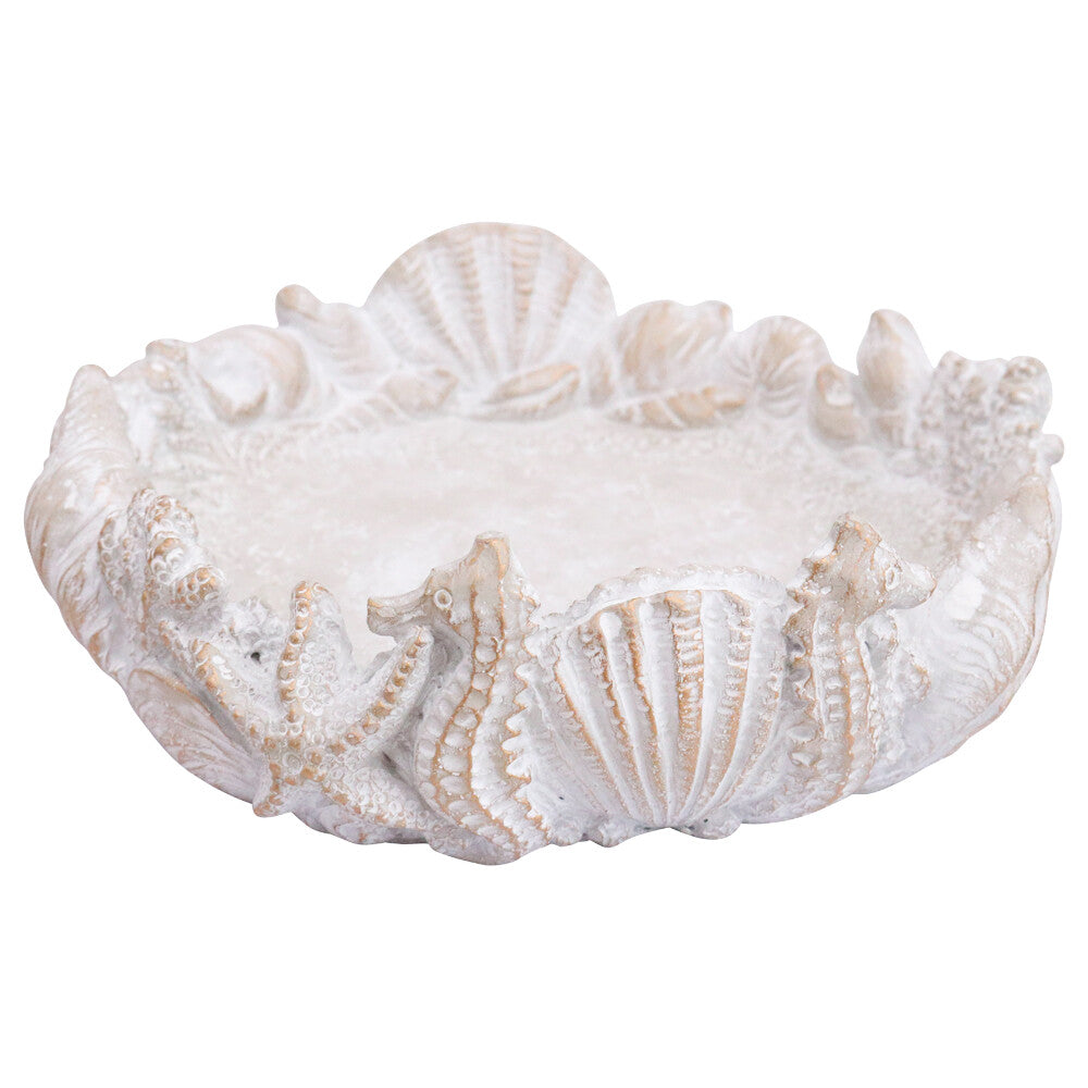 Cement seaside bird bath with seahorse, shell and starfish motifs around the rim