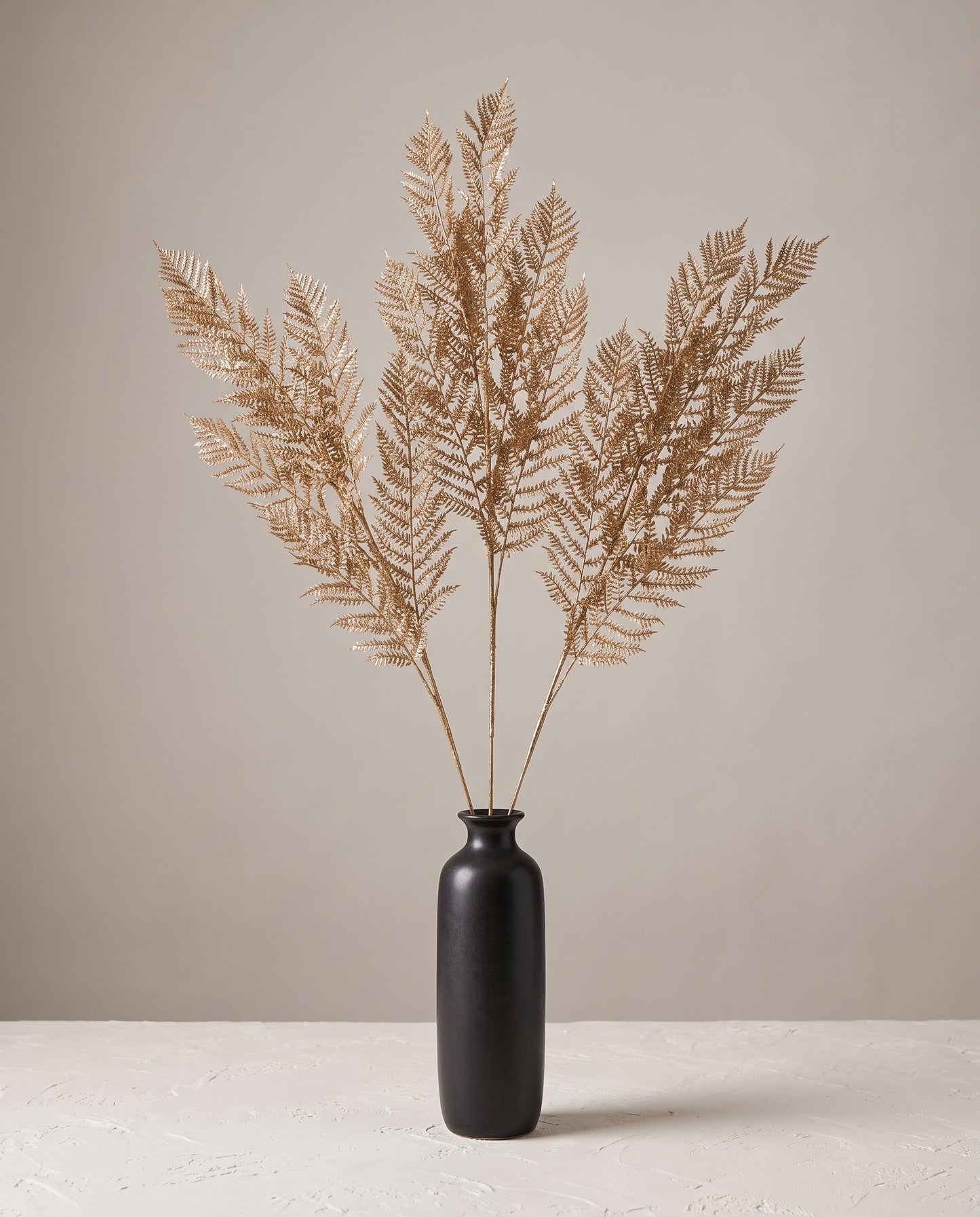 Fern Gold Stems in dark ceramic vase — Lumara Home