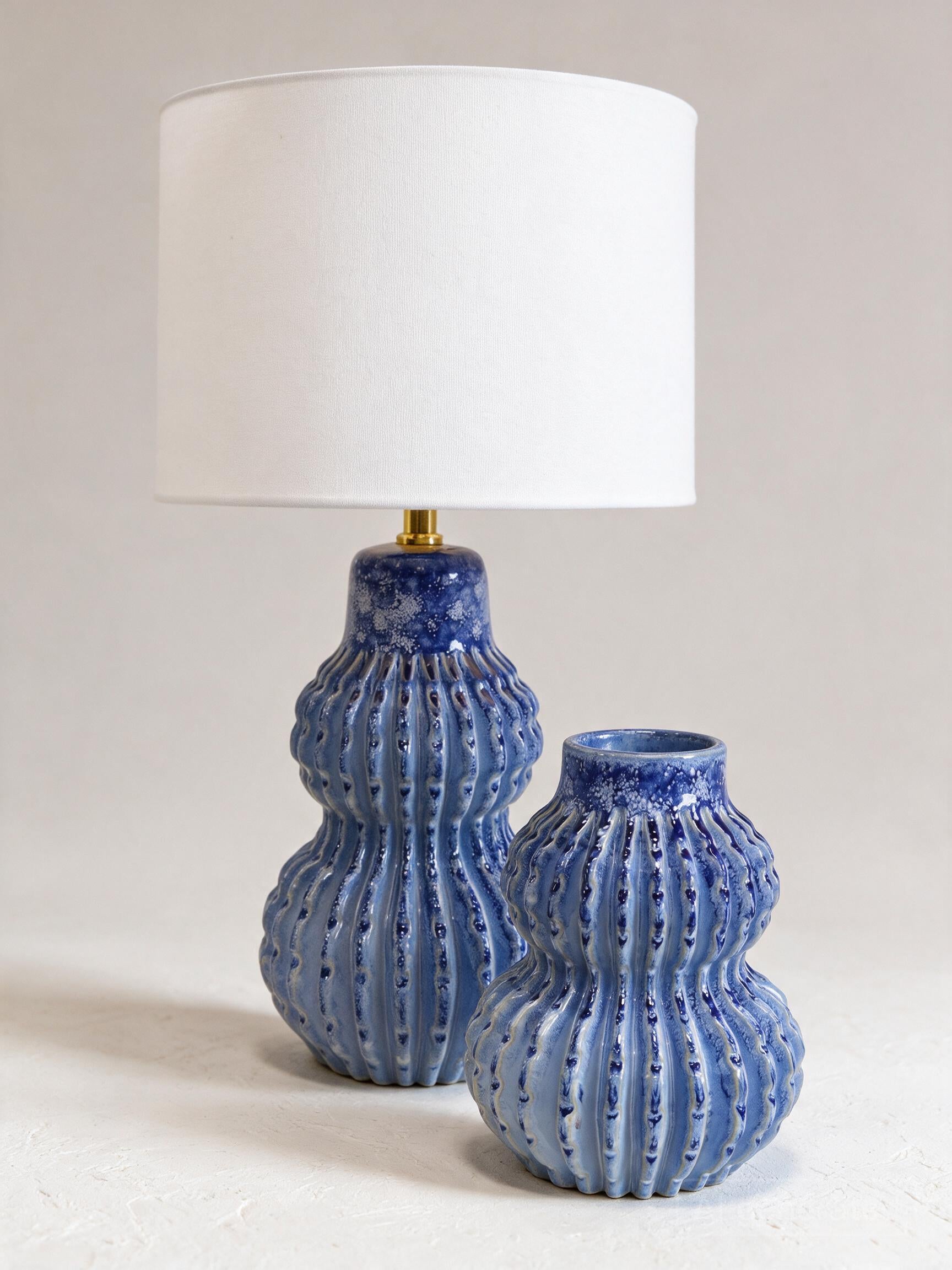 Malabar Duo lamp and vase, angled studio view showing ribbed blue glaze — Lumara Home