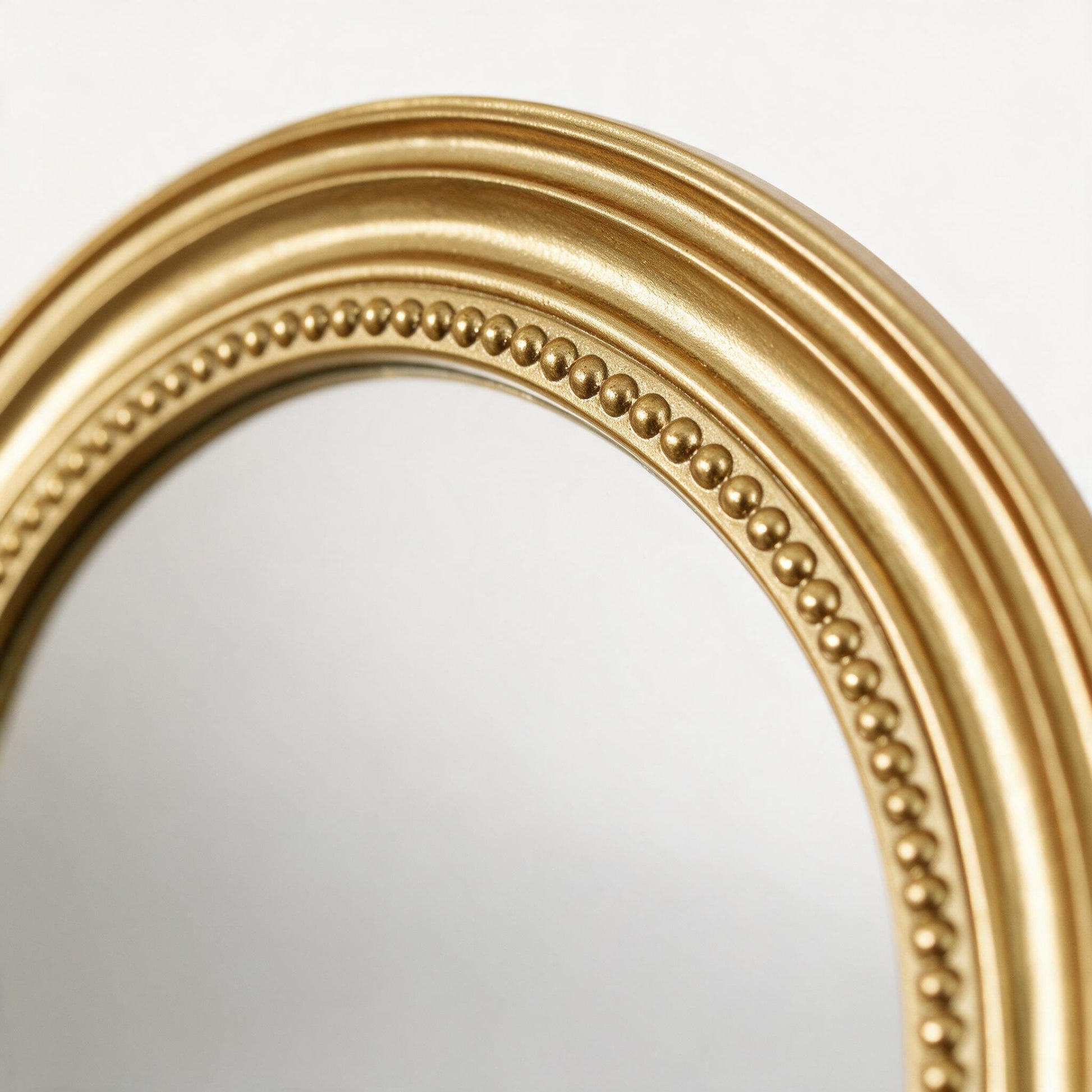 Close-up of the beaded gold frame detail on the Lumara Marbella Arch Mirror