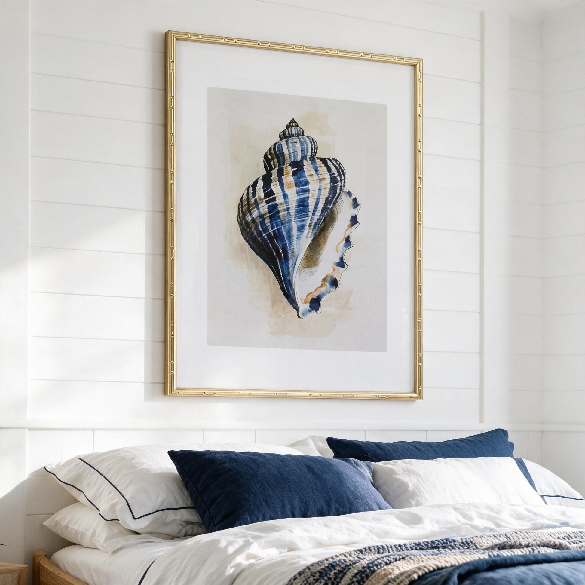 Navy shell framed print styled in a coastal Hamptons bedroom