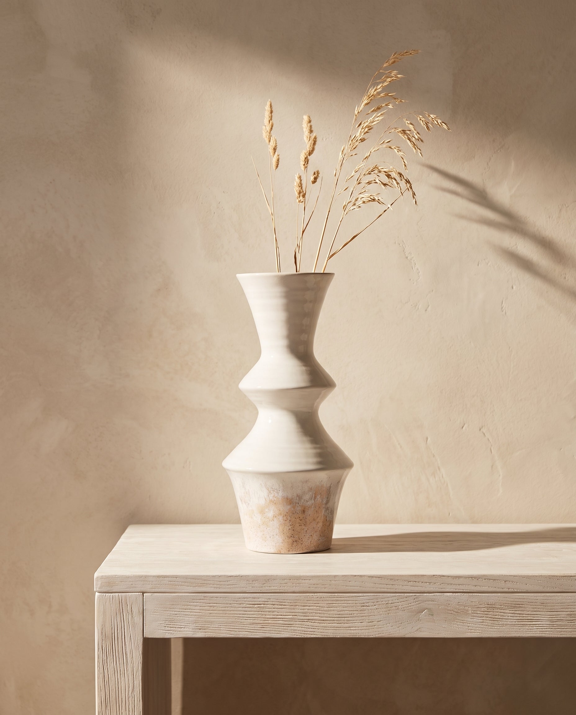 Lumara Mediterranean Statement Vase styled on a whitewashed timber console with dried grasses in warm Mediterranean sunlight