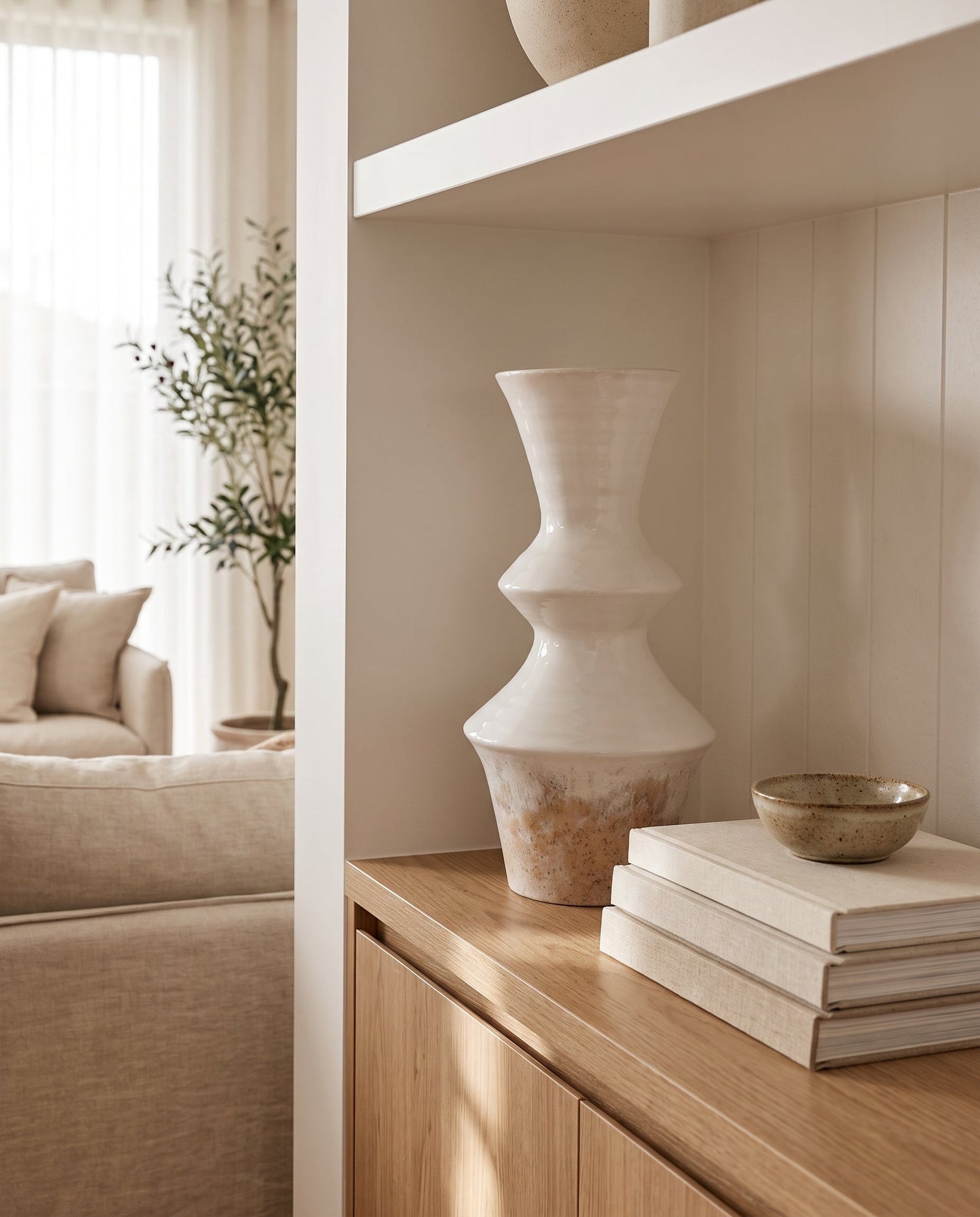 Lumara Mediterranean Statement Vase in a styled shelf vignette with linen-bound books and a ceramic bowl