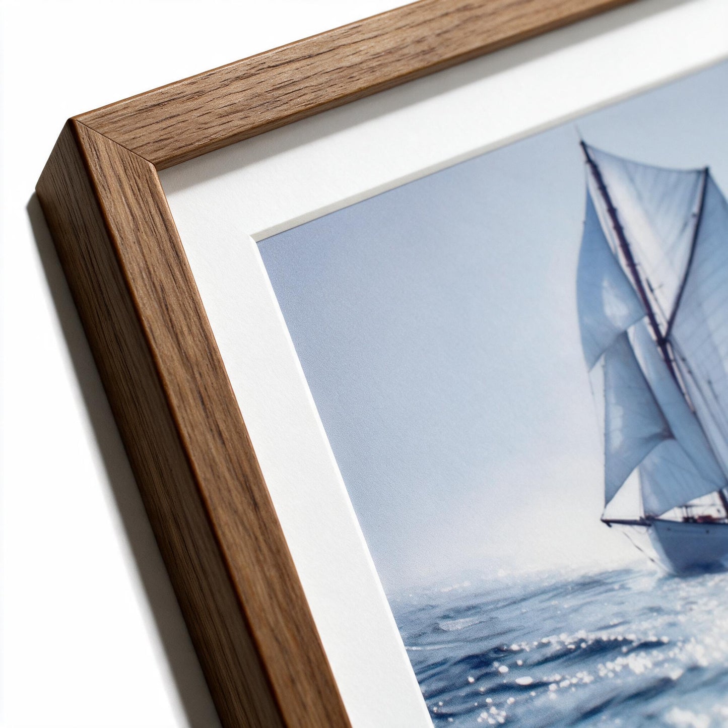Close-up of natural timber frame grain and white mat corner with part of the sail visible on the Lumara Solo Sailing framed print