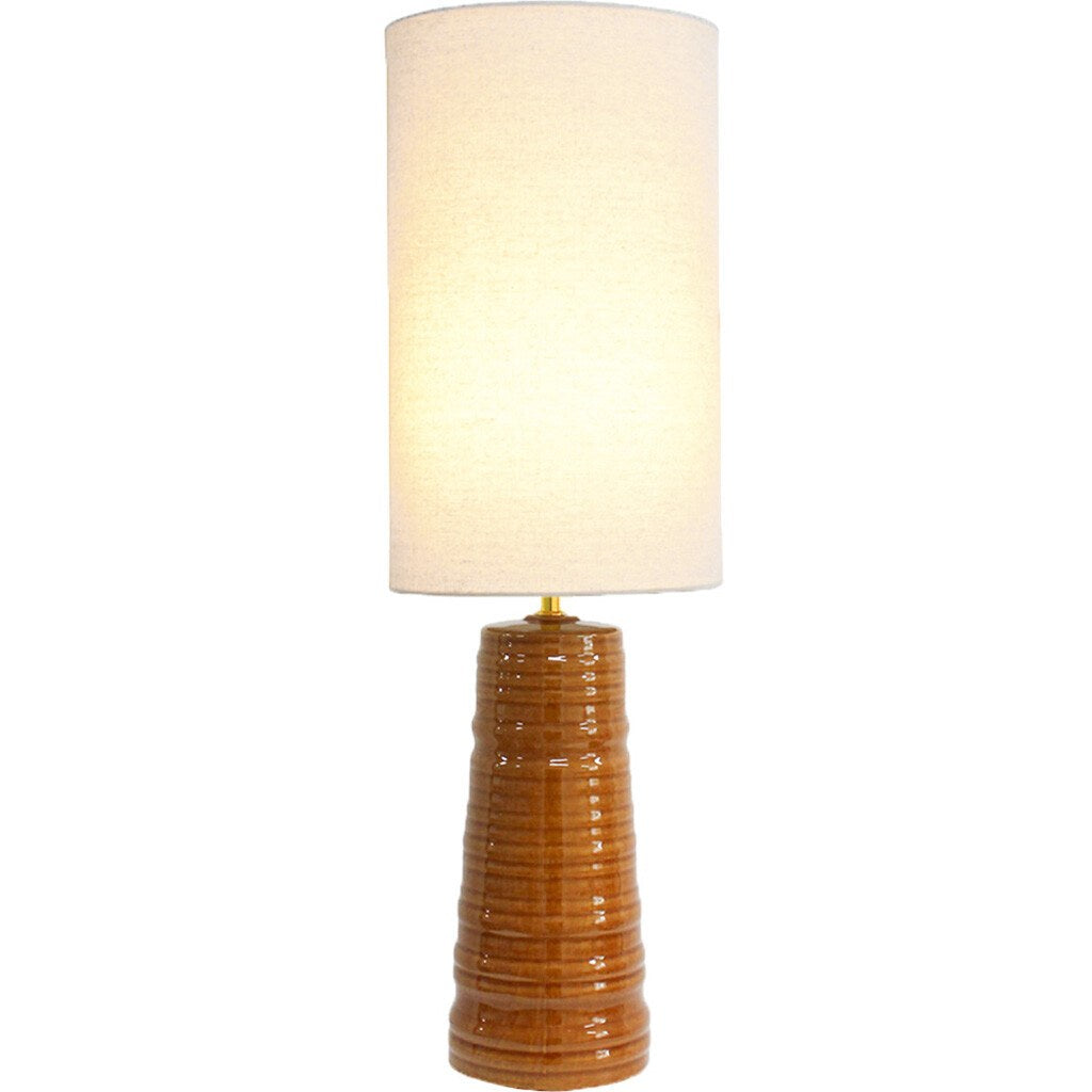 Lumara Spice Table Lamp — caramel ribbed ceramic base with linen shade, lit